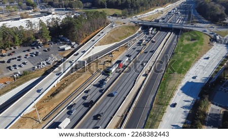 Busy traffic along Highway I-285 (the Perimeter) with under construction service road, bypass near Ashford Dunwoody in midtown Atlanta, Georgia, USA. Aerial view modern multiple lanes infrastructure
