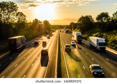 Busy Traffic On Uk Motorway Road Overhead View At Sunset