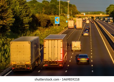 Busy Traffic On Uk Motorway Road Overhead View At Sunset