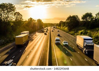 Busy Traffic On Uk Motorway Road Overhead View At Sunset