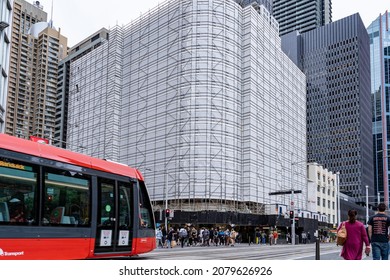 Busy Urban Scene Of Tram Train And Crowd Of People Walking To Cross Streets In Front Of Under Construction Building In Australian Central Business District In George Street Area Of Sydney 20 Nov 2021.