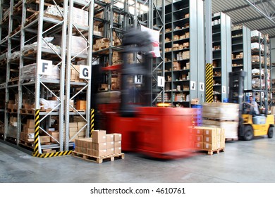 Busy Warehouse With Pallet Trucks Working