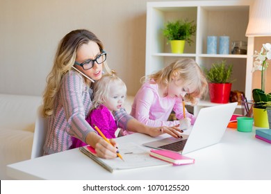 Busy woman trying to work while babysitting two kids