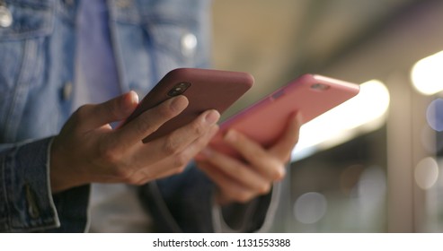 Busy Woman Using Two Mobile Phone Together