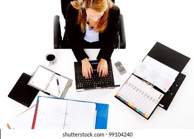 Busy Woman Working At Her Desk. View From Overhead Of Messy Desk And Multitasking Women