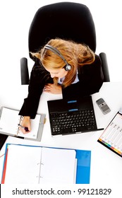 Busy Woman Working At Her Desk. View From Overhead Of Messy Desk And Multitasking Women