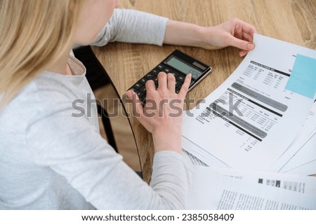 Busy woman working at home office calculating and paying utility bills for house rent. Managing finances or taxes, personal family budget planning. Accounting concept