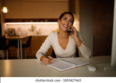 Busy Woman, Working Late, Writing Some Plans While Talking Over The Phone.