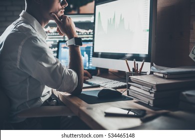 Busy working day. Close-up of young businessman looking at monitor while sitting at the desk in creative office  - Shutterstock ID 534465148