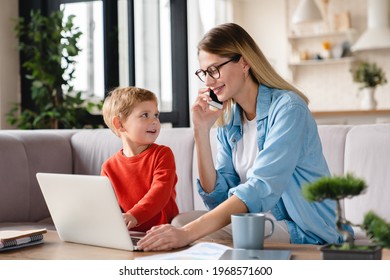 Busy working remotely mother taking care of her little toddler baby son kid child on freelance using laptop. Multitasking work. Maternity leave concept