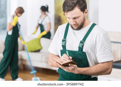 Busy Young Boss Of Cleaning Company Writing Down The Notes