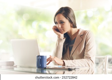 Busy Young Business Woman Working At Desk Typing On A Laptop