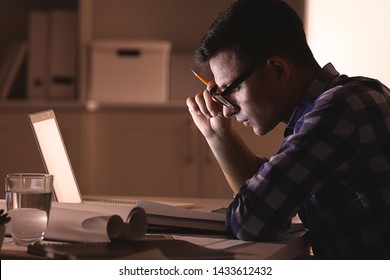 Busy Young Man Working At Home Late In Evening