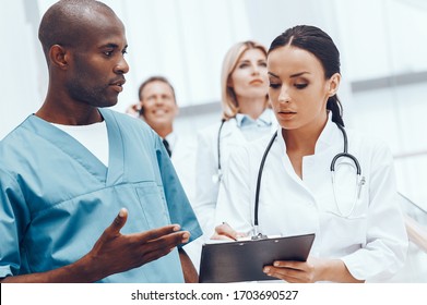 Busy Young Medical Team Communicating Together While Working In The Hospital