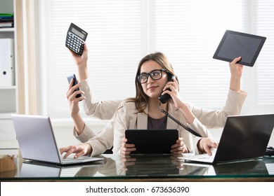 Busy Young Smiling Businesswoman With Six Arms Doing Different Type Of Work In Office