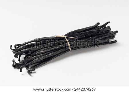 Butch of vanilla beans. Close up dry vanilla sticks on grey background.