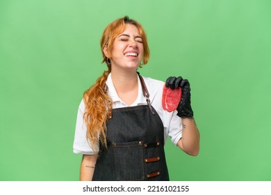 Butcher Caucasian Woman Wearing An Apron And Serving Fresh Cut Meat Isolated On Green Screen Chroma Key Background Laughing