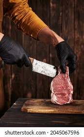 The Butcher Cuts The Meat With Gloves.