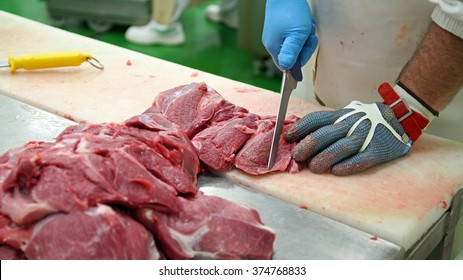 Butcher Cutting Pork Meat into Pieces for a Meat Market.
Fresh raw pork chops in meat factory. Meat processing in food industry. - Powered by Shutterstock