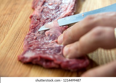 Butcher finishes Raw Skirt Steak for the barbecue - Powered by Shutterstock