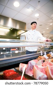 A Butcher Helping A Customer At A Fresh Meat Counter Or Deli