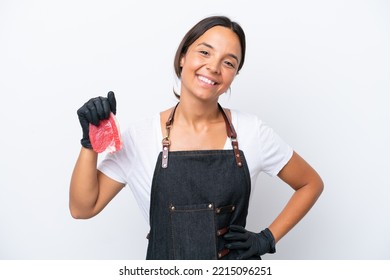 Butcher Hispanic Woman Wearing An Apron And Serving Fresh Cut Meat Isolated On White Background Posing With Arms At Hip And Smiling