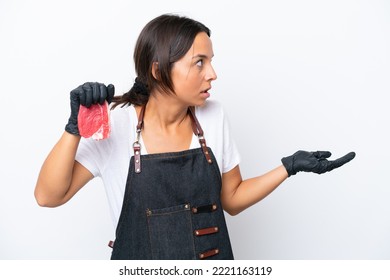 Butcher Hispanic Woman Wearing An Apron And Serving Fresh Cut Meat Isolated On White Background With Surprise Expression While Looking Side