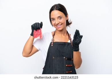 Butcher Hispanic Woman Wearing An Apron And Serving Fresh Cut Meat Isolated On White Background Inviting To Come With Hand. Happy That You Came