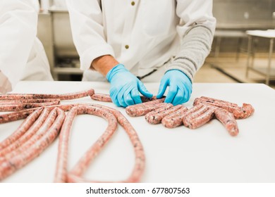 Butcher Making Sausage Links In A Butcher's Shop.