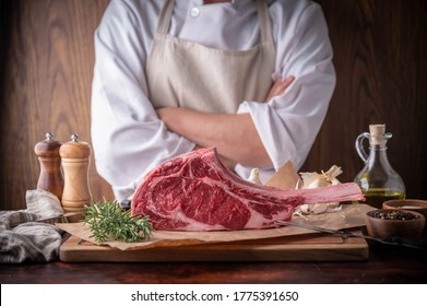 butcher serving fresh tomahawk steak meat to customer - Powered by Shutterstock