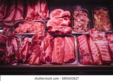 Butcher shop's meat window with meat packs. Different products in meat market. Meat counter. - Powered by Shutterstock