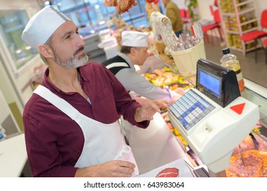 Butcher weighing meat - Powered by Shutterstock