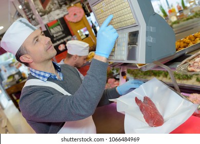 Butcher weighing piece of steak - Powered by Shutterstock