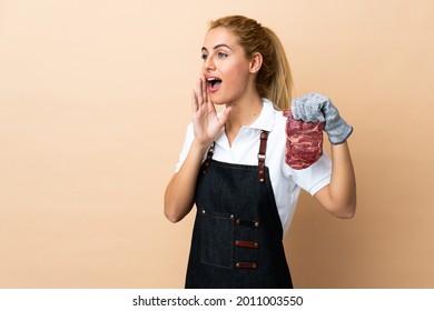 Butcher Woman Wearing An Apron And Serving Fresh Cut Meat Over Isolated Background Shouting With Mouth Wide Open