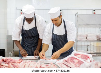 butchers packing meat pieces in butchery