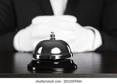 Butler at desk with service bell, closeup view
