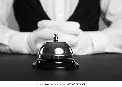 Butler at desk with service bell, closeup view