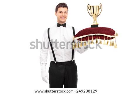 Butler holding a trophy on red pillow isolated on white background