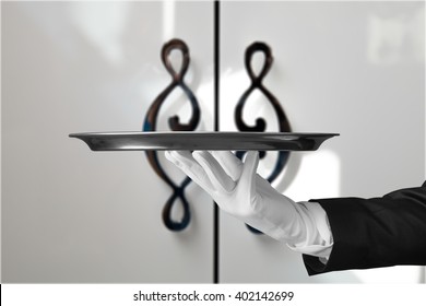 Butler Serving Empty Silver Tray.