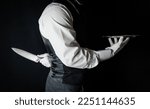 Butler or Waiter With Serving Tray and Holding Sharp Knife Behind Back. Concept of Butler Did It. Classic Murder Mystery.