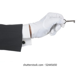 Butler's gloved hand holding an old key isolated over white. Hand and arm only in horizontal format.