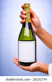 Butler's Hand Holding A Bottle Of Champagne With Blank Label