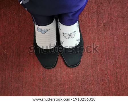 Buttefly pattern socks with unmatched design. 