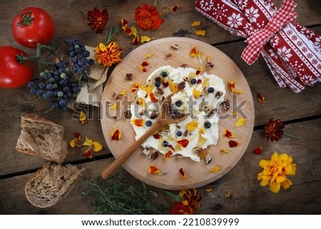 Butter board food trend, butter spread on wooden board with sweet toppings of honey and pecans