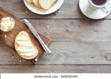 Butter and bread for breakfast, with cup of coffee over rustic wooden background with copy space. Morning breakfast with coffee, butter and toasts. - Powered by Shutterstock