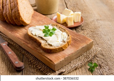 Butter and bread for breakfast, with parsley over rustic wooden background with copy space - Powered by Shutterstock