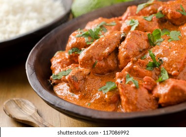 Butter chicken curry with basmati rice and limes.
