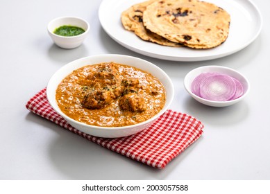 Butter Chicken Gravy Served In A White Bowl With Flatbread Chapati Or Naan