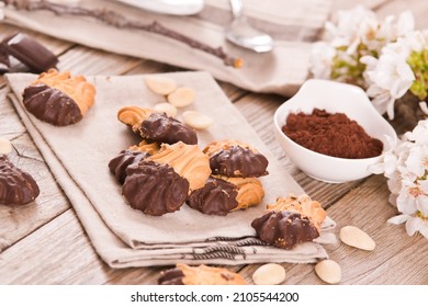 Butter cookies with chocolate on wooden table.