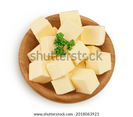 butter cubes in wooden bowl isolated on white background with clipping path and full depth of field. Top view. Flat lay